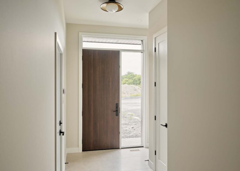 Front entryway with wood door and sidelight
