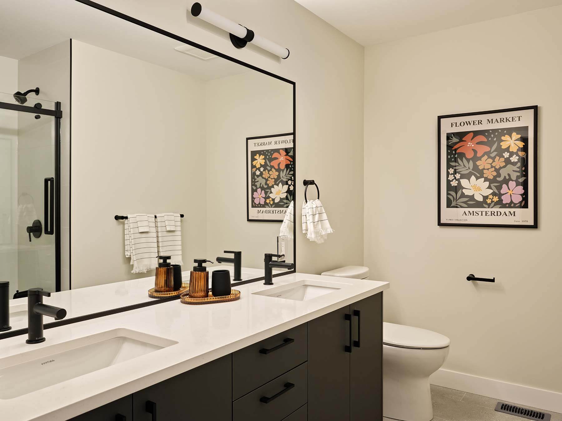 Bathroom with double vanity and glass shower