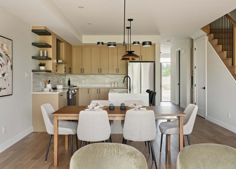 Dining area facing the light wood kitchen