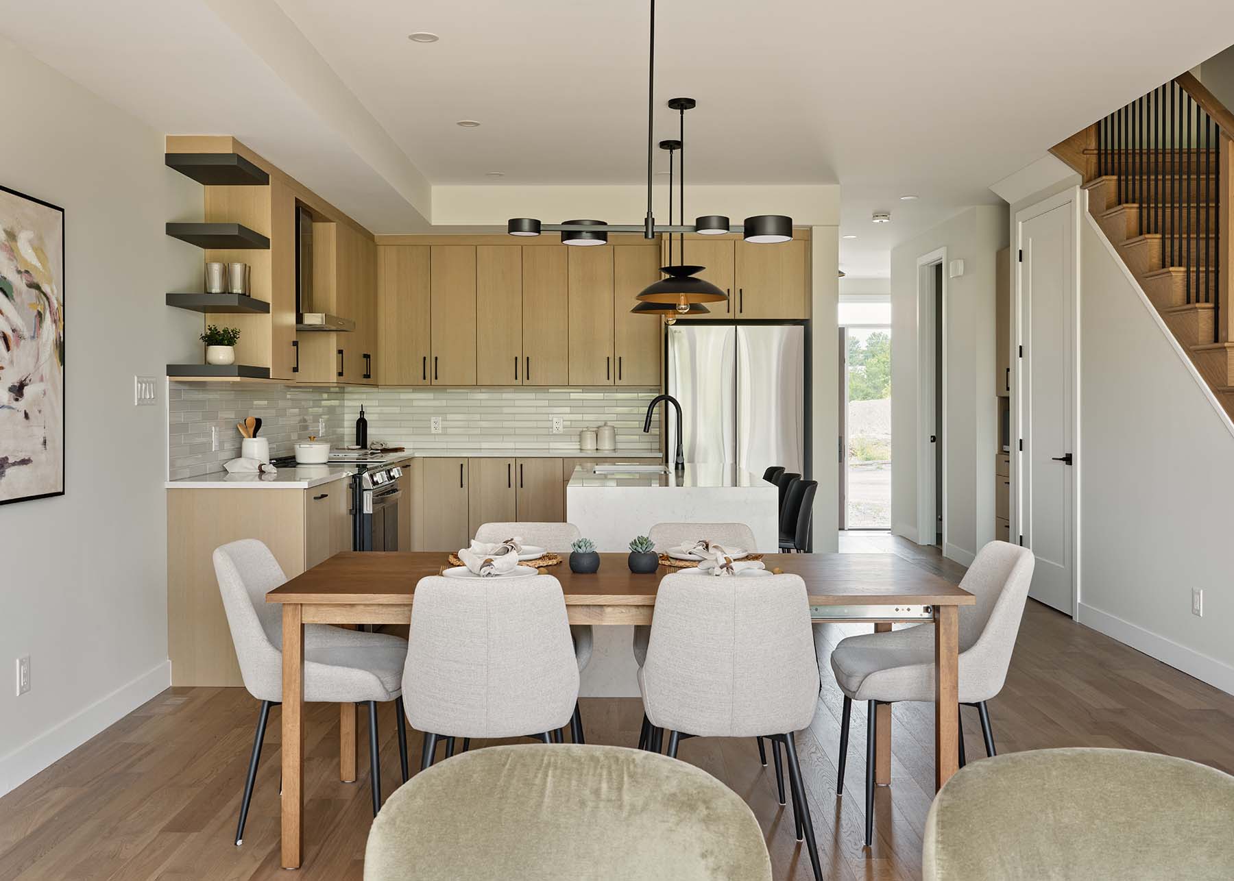 Dining area facing the light wood kitchen