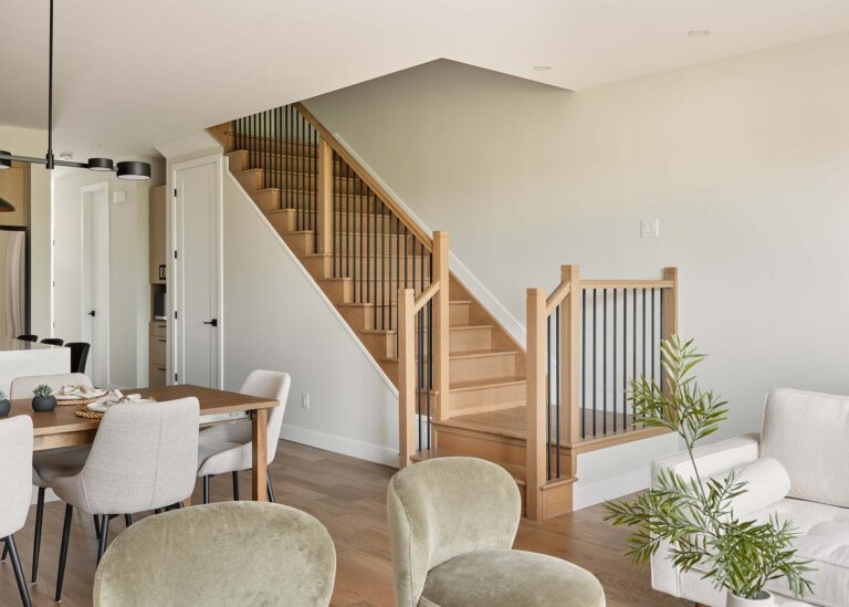 Staircase beside the open-concept living and dining area