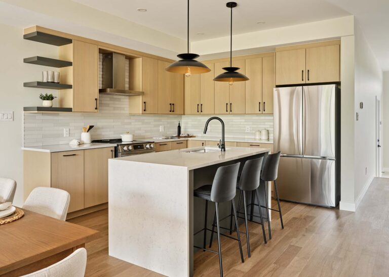 Light wood kitchen with waterfall island and bar seating