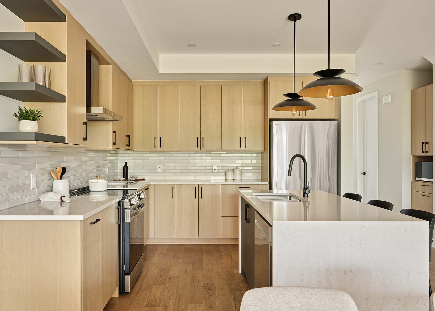 Modern kitchen with light wood cabinetry and island